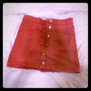 Bright pink mini skirt.